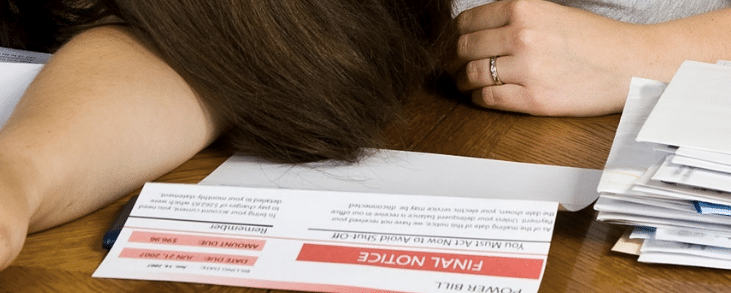 paperwork sitting on desk with person's hands showing