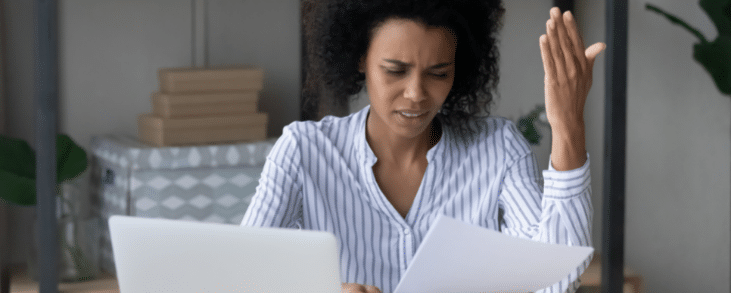 black woman looking at bill frustrated