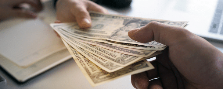 handing cash to another person