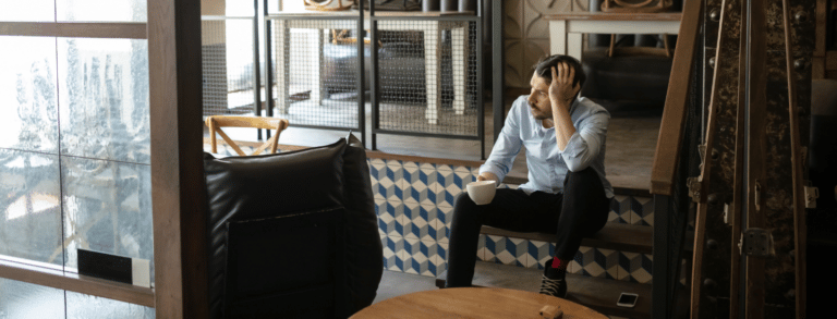 white male business onwer sitting looking stressed out